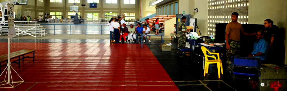 US Navy 081015-N-4515N-185 Dominicans wait patiently for their turn to be screened by eye doctors at a sports complex in Sabana Grande