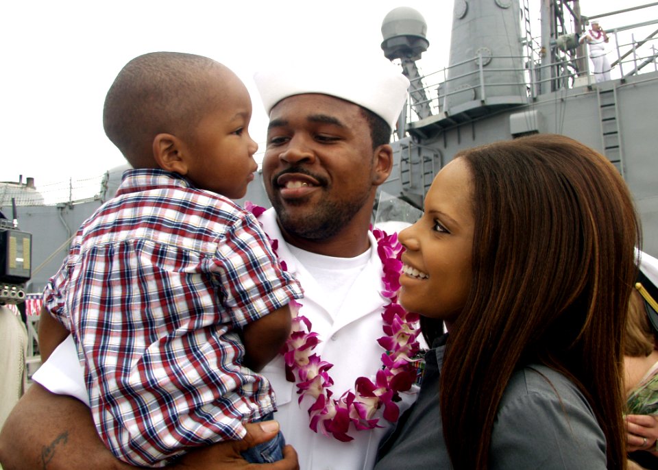 US Navy 081219-N-0879R-002 A Sailor greets his wife and son