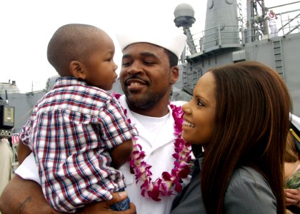 US Navy 081219-N-0879R-002 A Sailor greets his wife and son