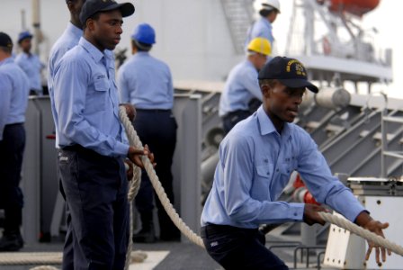 US Navy 081018-N-1635S-004 Seaman Beniam Yebio mans a mooring line aboard the Ticonderoga-class guided-missile cruiser USS Chancellorsville (CG 62) while connecting to the pier at Goa, India