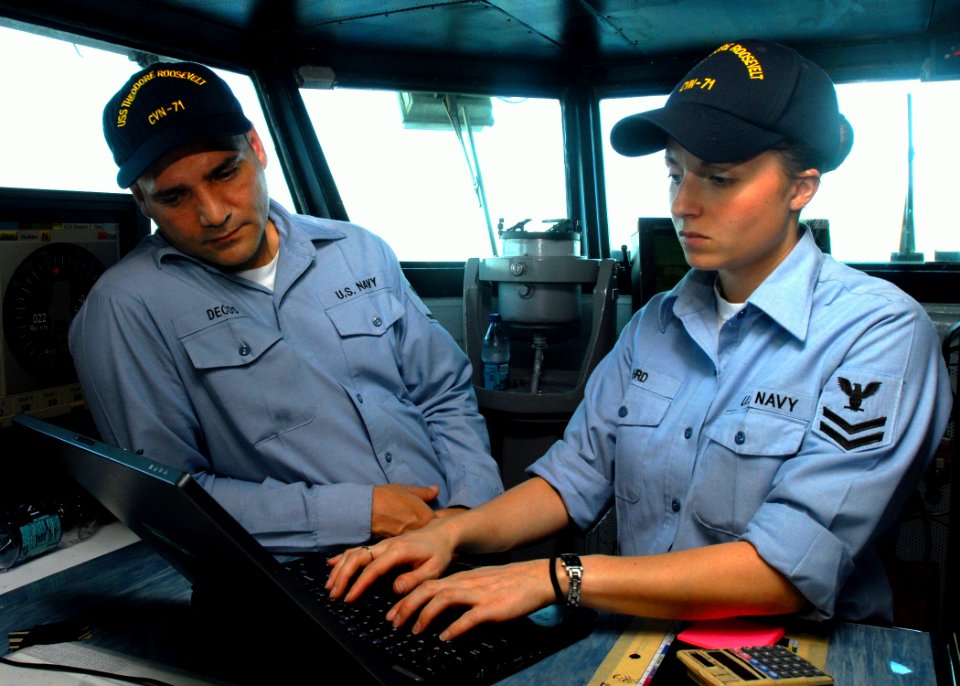 US Navy 081018-N-2456S-196 Quartermaster 2nd Class Kathryn Herd and Quartermaster 3rd Class Alexander Decos update the deck log on the bridge of the aircraft carrier USS Theodore Roosevelt (CVN 71)