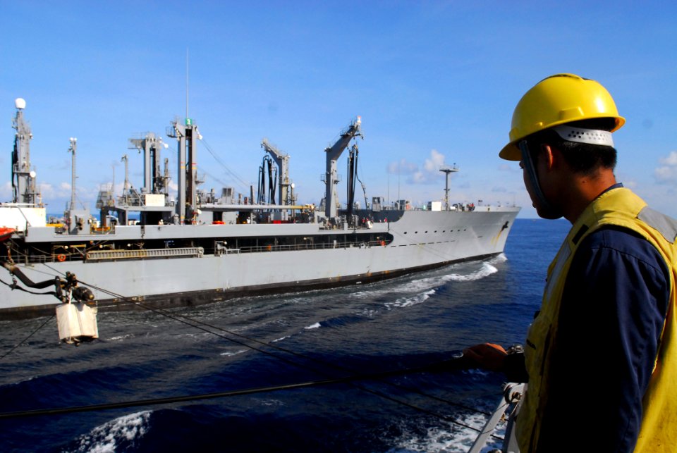 US Navy 081017-N-2013O-004 Boatswain's Mate 2nd Class Glenboy Guilas watches a fuel line