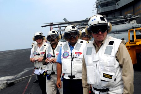 US Navy 081021-N-3659B-260 Rear Adm. Phillip J. Wisecup and Rear Adm. Anil Chopra watch flight operations on the flight deck of the Nimitz-class aircraft carrier USS Ronald Reagan (CVN 76) photo