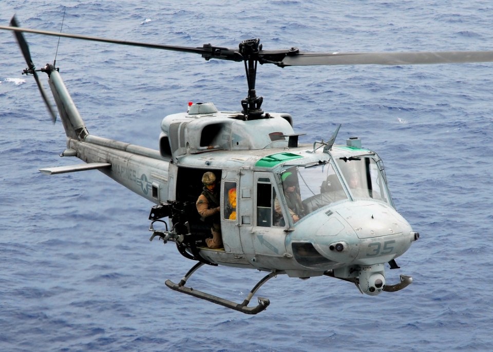 US Navy 081017-N-2183K-014 A UH-1N Twin Huey helicopter gunship approaches the flight deck of the amphibious assault ship USS Peleliu (LHA 5)