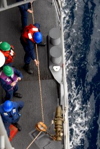 US Navy 081020-N-1635S-005 Sailors retrieve line aboard the Ticonderoga-class guided-missile cruiser USS Chancellorsville (CG 62) while conducting a replenishment at sea with the Military Sealift Command fast combat support shi