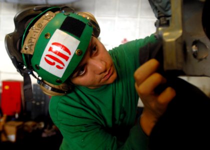 US Navy 081022-N-2456S-042 Aviation Machinist's Mate Airman Jennifer Buentello cleans corrosion on the rotor blade head of an SH-60F
