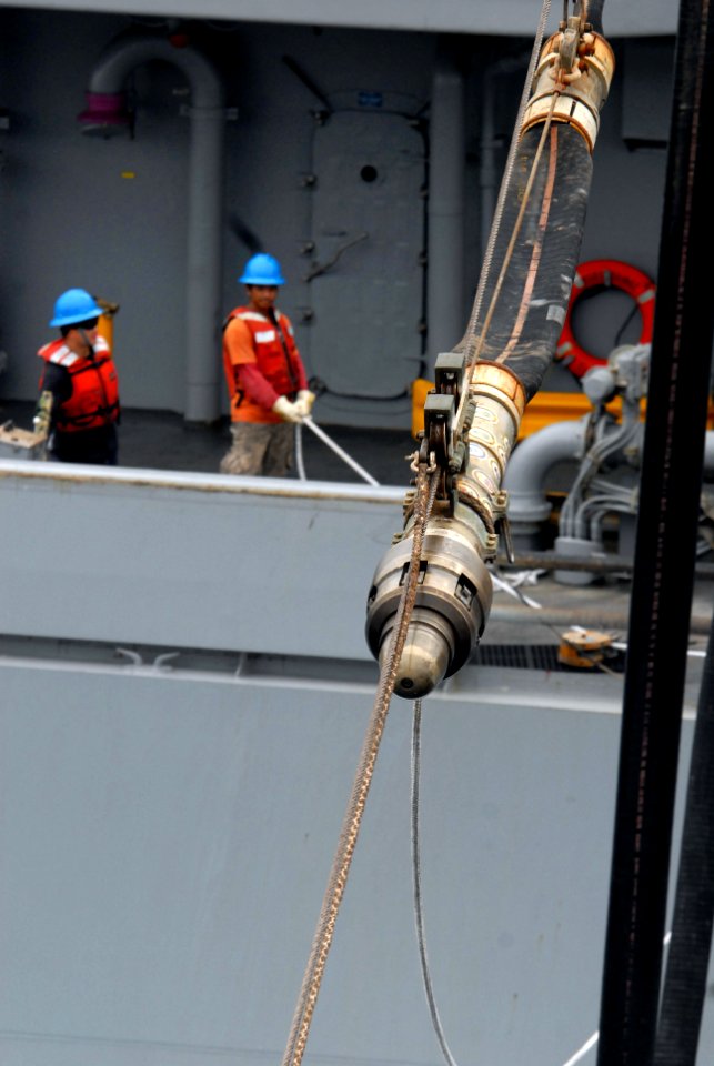 US Navy 081020-N-1635S-006 Sailors aboard the Military Sealift Command fast combat support ship USNS Bridge (T-AOE 10) transfer a fuel line to the Ticonderoga-class guided-missile cruiser USS Chancellorsville (CG 62) while cond