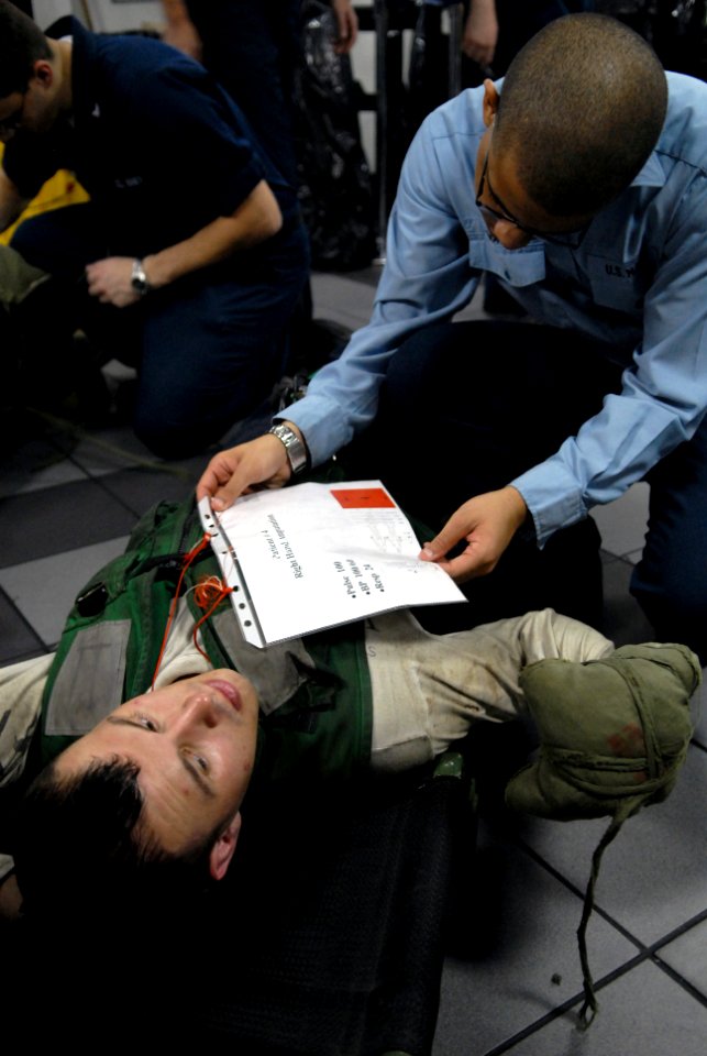 US Navy 081022-N-1635S-003 Hospital Corpsman David Small checks the status of a personnel casualty