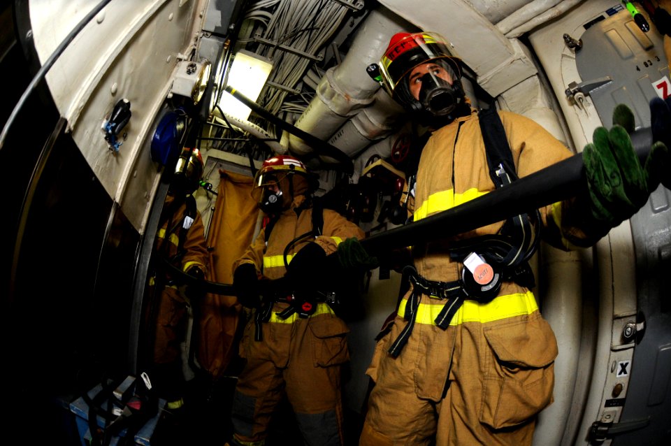 US Navy 081029-N-8546L-015 Sailors maintain positive control of an aqueous film forming foam hose