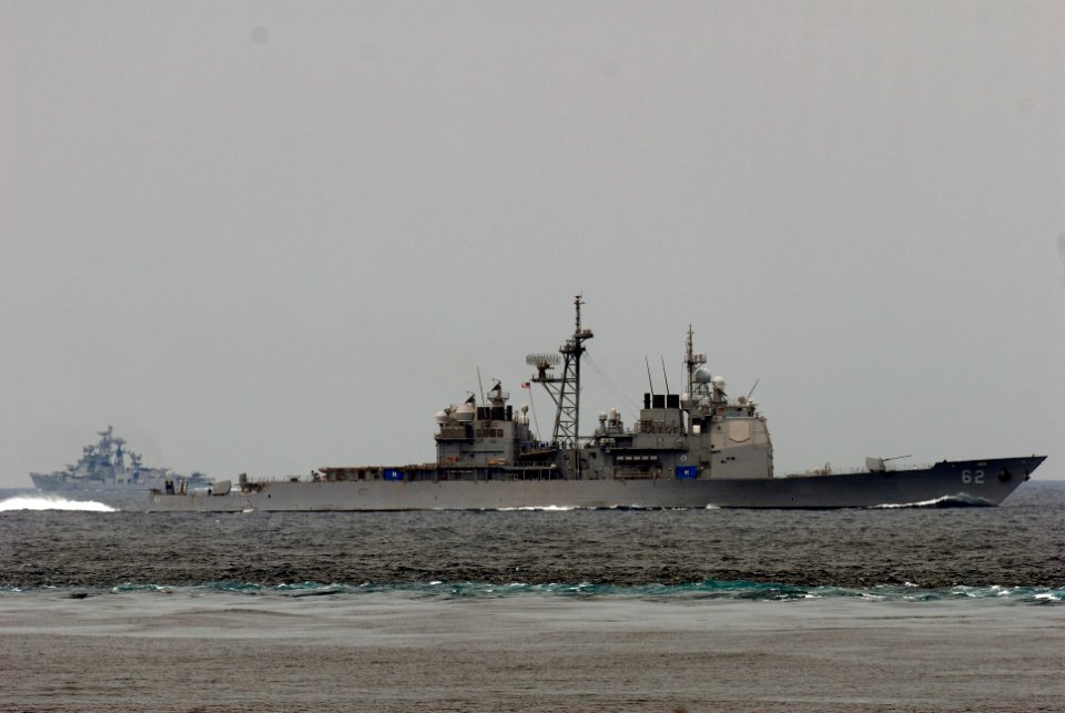 US Navy 081022-N-7730P-037 The Ticonderoga-class guided missile cruiser USS Chancellorsville (CG 62) parallels the wake of the Nimitz-class aircraft carrier USS Ronald Reagan (CVN 76)