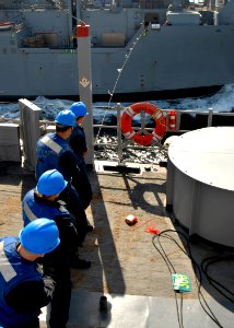 US Navy 090107-N-3392P-087 Line handlers maintain tension on the phone and distance line