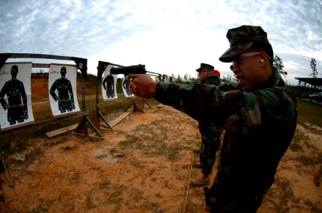 US Navy 081023-N-3674H-123 Engineering Aid 3rd Class Adolfo Valdez fires a M9 9mm pistol photo