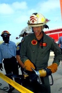 US Navy 081018-N-3289C-008 Capt. Bill Mosk cuts a ribbon with the Jaws of Life for the opening of a new fire fighting training center photo