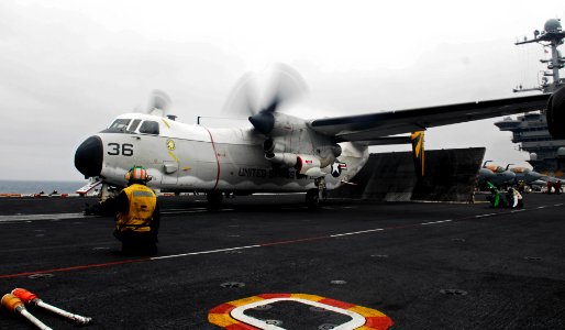 US Navy 081020-N-9928E-040 Aviation Boatswain's Mate (Equipment) 2nd Class Saul Araza holds the safe to launch signal for a C-2A Greyhound