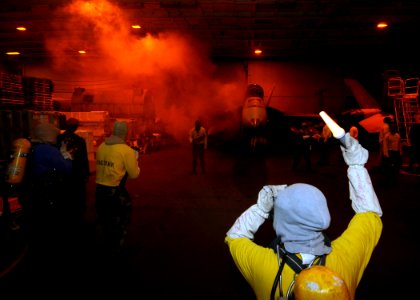 US Navy 081020-N-8534H-025 Aircraft carrier USS George Washington (CVN 73) Sailors fight a simulated fire in hangar bay three during a general quarters drill