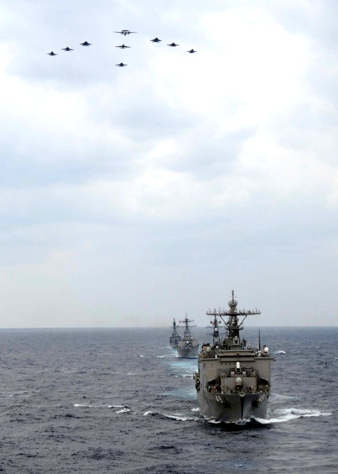 US Navy 081119-N-1644H-103 Carrier Air Wing Five (CVW 5) and Japan Air Self-Defense Force aircraft fly over USS Harpers Ferry (LSD 49)