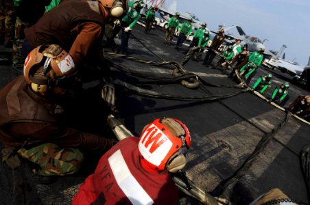 US Navy 081022-N-3659B-214 Sailors help to rig the training barricade during flight deck drills photo