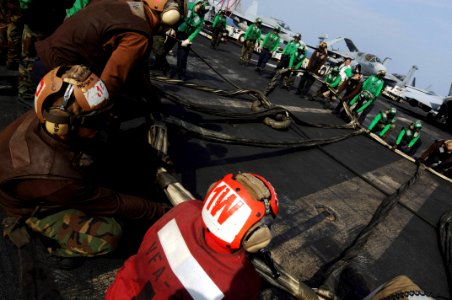 US Navy 081022-N-3659B-214 Sailors help to rig the training barricade during flight deck drills