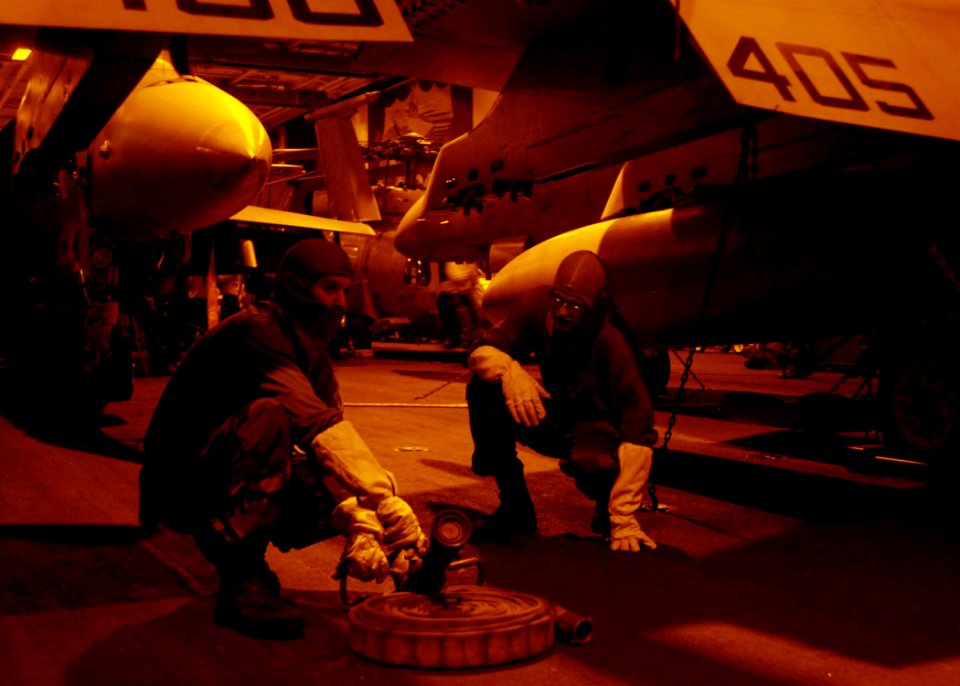 US Navy 081020-N-1038M-055 Aircraft carrier USS George Washington (CVN 73) Sailors prepare to use a 3-in. fire hose to cool down a hangar bay door during a simulated fire while participating in a general quarters drill