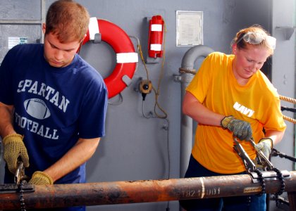 US Navy 081022-N-5148B-016 Ensign James Blanchet and Ensign Salina Leyk compete in a pipe patching competition