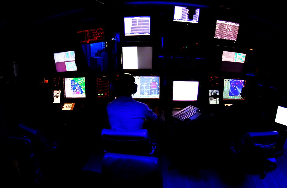 US Navy 081024-N-6538W-008 Operations Specialist 3rd Class Keegan Wigger, from Olympia, Wash., monitors air radar contacts in the Combat Direction Center aboard the Nimitz-class aircraft carrier USS John C. Stennis (CVN 74)