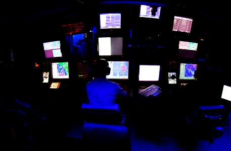 US Navy 081024-N-6538W-008 Operations Specialist 3rd Class Keegan Wigger, from Olympia, Wash., monitors air radar contacts in the Combat Direction Center aboard the Nimitz-class aircraft carrier USS John C. Stennis (CVN 74)