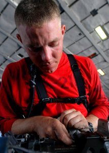 US Navy 081023-N-2456S-037 Aviation Ordnanceman 2nd Class Gregory Wolfe cleans the rotor of the M61A2 20mm Automatic Gun