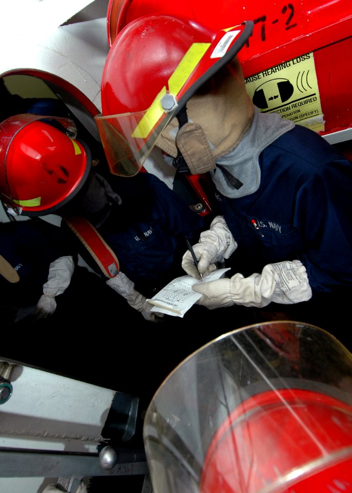 US Navy 081020-N-6984M-029 Aircraft carrier USS George Washington (CVN 73) Sailors fill out a message blank to describe damage sustained to an area of the ship during a general quarters drill