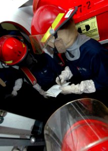 US Navy 081020-N-6984M-029 Aircraft carrier USS George Washington (CVN 73) Sailors fill out a message blank to describe damage sustained to an area of the ship during a general quarters drill