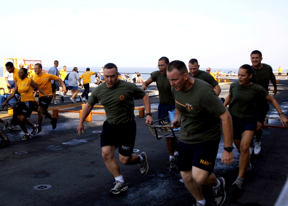 US Navy 081024-N-4236E-151 Sailors and Marines participate in a stretcher bearer obstacle course during physical training