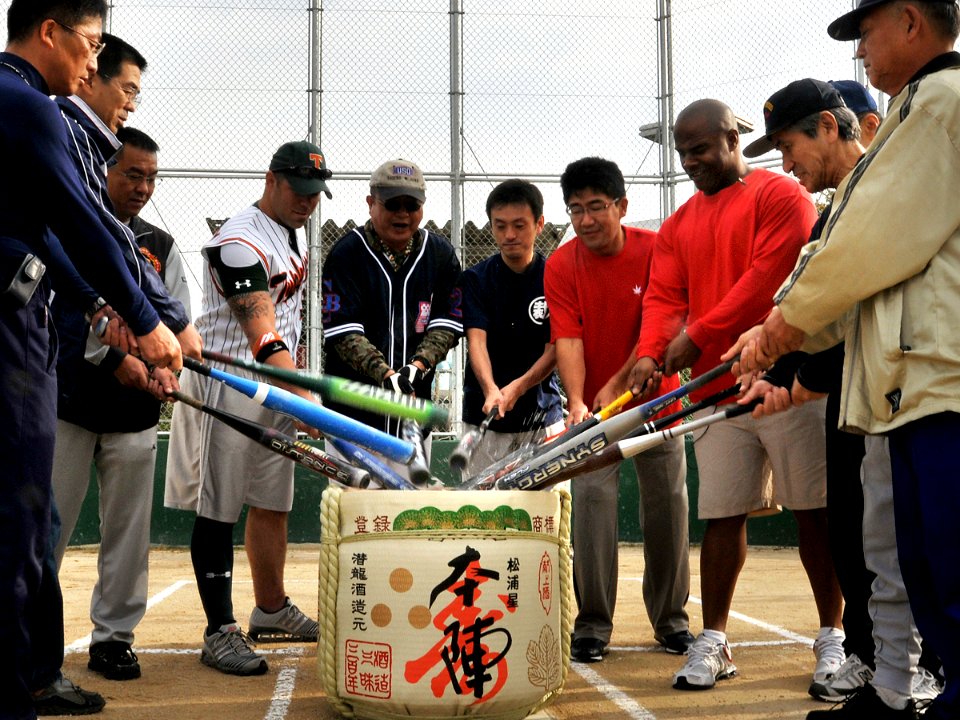 US Navy 081025-N-0807W-097 Members of the Fleet Activities Sasebo Security Detachment exchange bows with their Japanese counterparts.softball team the