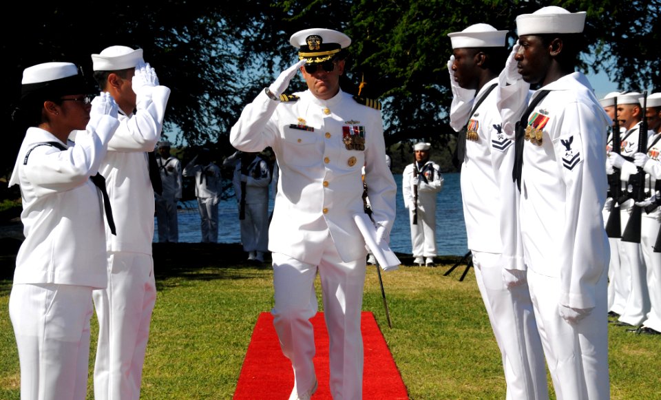 US Navy 081023-N-9758L-015 Capt. David Adler salutes as he is piped through sideboys
