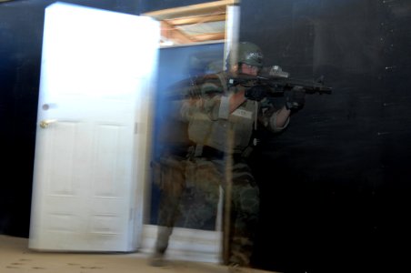 US Navy 081023-N-6552M-036 A Navy SEAL trainee tactically enters a room during a close quarters combat exercise photo