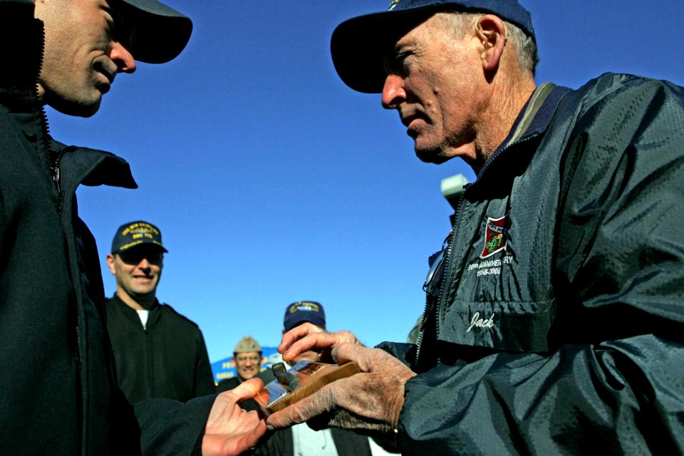 US Navy 081023-N-7441H-002 Navy veteran and diver Jack Monro presents Chief Sonar Technician Stephen Aderhold a spike from the first USS New Hampshire, a 74-gun ship of the line laid down in 1819 and launched in 1864 from Ports