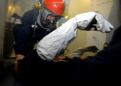 US Navy 081024-N-1038M-016 An investigator removes a casualty from a smoke filled space