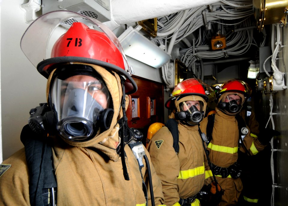 US Navy 081024-N-9565D-002 Sailors await reports of any damage in their area of responsibility during a general quarters drill