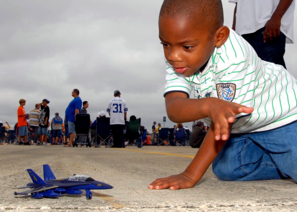 US Navy 081025-N-1522S-097 A young boy plays with his Blue Angel model plane