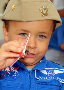 US Navy 081025-N-1522S-257 A young boy plays with a model plane at the 2008 Wings of Freedom Air Show