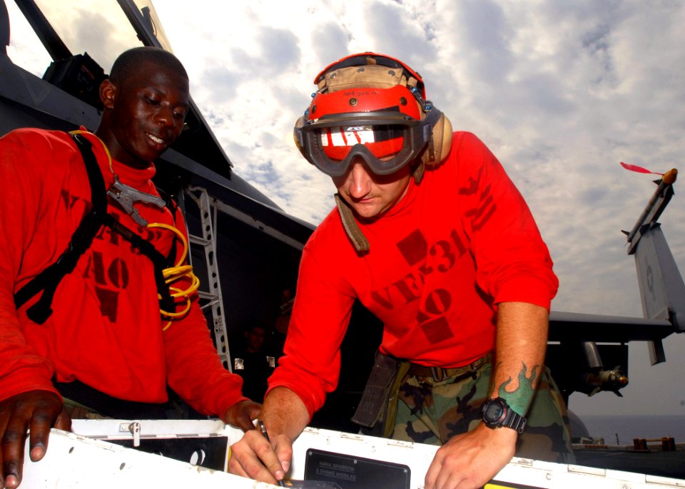 US Navy 081022-N-2456S-020 Aviation Ordnanceman 1st Class Charles Richardson shows Aviation Ordnanceman Airman Curtis Johnson how to prepare the rounds for the 20mm Vulcan gun