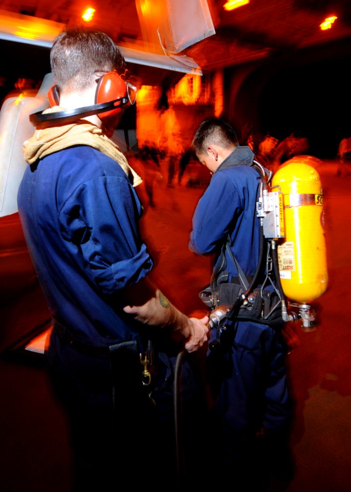 US Navy 081024-N-9565D-019 A Sailor refills a self-contained breathing apparatus after a general quarters drill aboard the aircraft carrier USS George Washington (CVN 73)