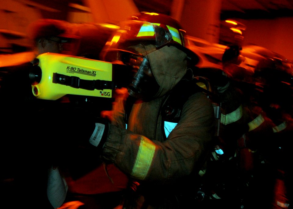 US Navy 081024-N-8534H-001 A hose team leader uses a Naval Firefighters Thermal Imager (NFTI) to guide his team during a general quarters drill aboard the aircraft carrier USS George Washington (CVN 73)