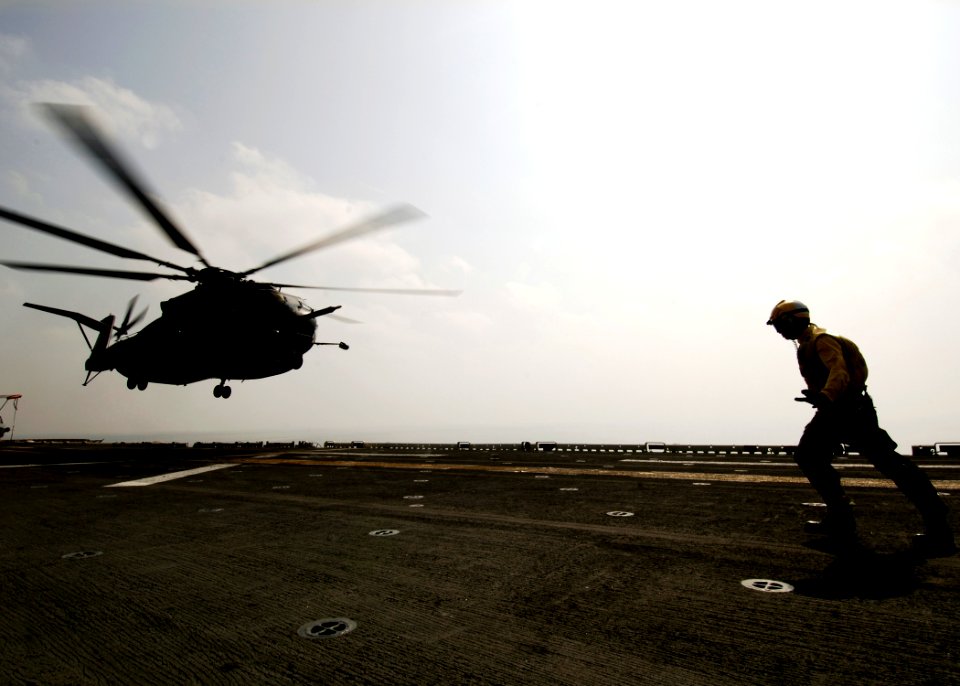 US Navy 081027-N-4236E-047 Aviation Boatswain's Mate (Handling) 3rd Class Mariel Ramirez directs an MH-53E Sea Dragon helicopter as it lands on the amphibious assault ship USS Iwo Jima (LHD 7)