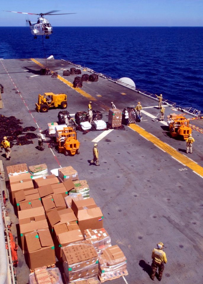 US Navy 081025-N-5253W-017 An SA330J Puma helicopter lowers a pallet of supplies to the flight deck of the amphibious assault ship USS Essex (LHD 2)