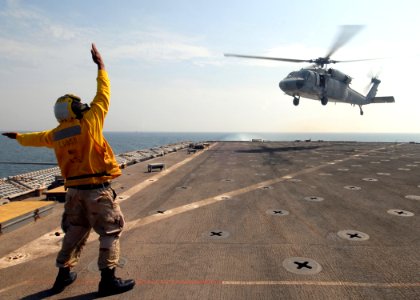 US Navy 081025-N-9134V-061 Seaman James Buchanan directs an SH-60B
