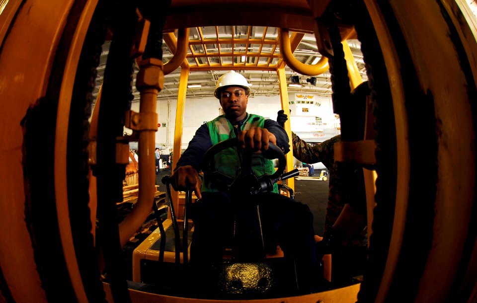 US Navy 081028-N-9928E-184 Store Keeper Seaman Jeremy Donaldson from Chicago, moves supplies in the hangar bay of the Nimitz-class aircraft carrier USS John C. Stennis (CVN 74)