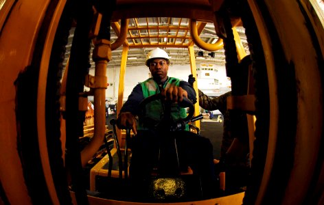 US Navy 081028-N-9928E-184 Store Keeper Seaman Jeremy Donaldson from Chicago, moves supplies in the hangar bay of the Nimitz-class aircraft carrier USS John C. Stennis (CVN 74)