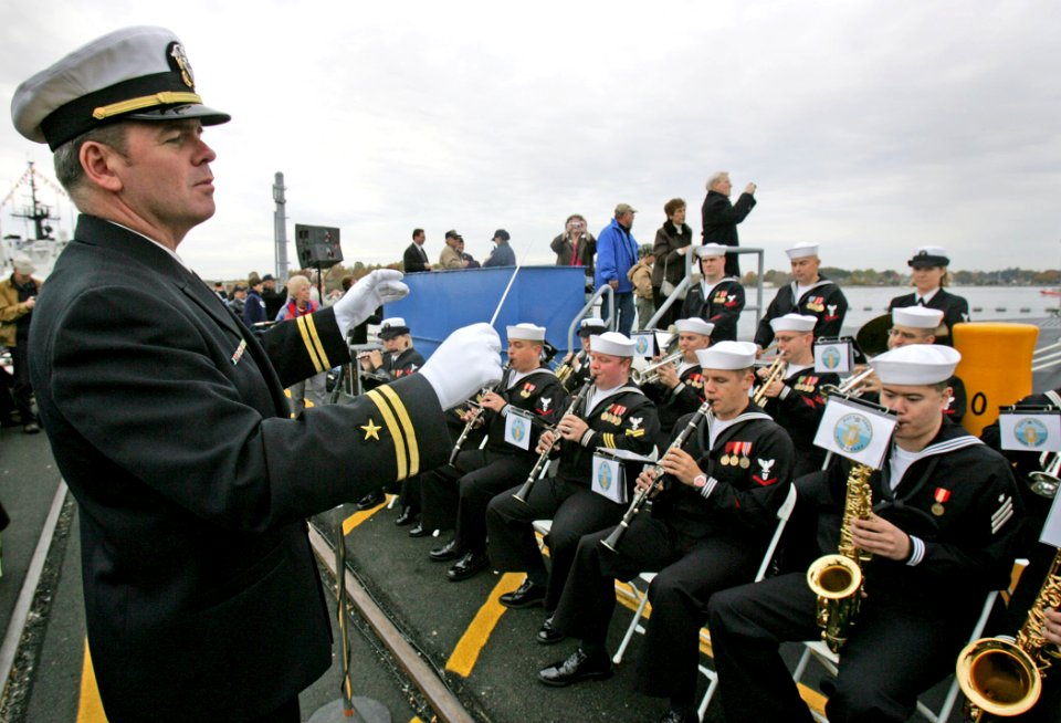 US Navy 081025-N-7441H-002 Lt. Carl Gerhard leads the Navy Band Northeast in a musical selection before the commissioning ceremony for the Virginia-class attack submarine USS New Hampshire (SSN 778)