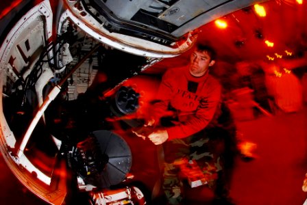 US Navy 081026-N-6538W-093 Aviation Ordnanceman 2nd Class Hunter Owens, from Baton Rouge, La., reinstalls an M-61A1 20mm Gatling gun in the gun bay of an F-A-18C Hornet assigned to the