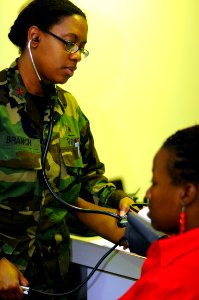 US Navy 081026-N-4515N-065 Lt. Cmdr. Tracy Branch checks the blood pressure of a women at the Arima District Health Facility