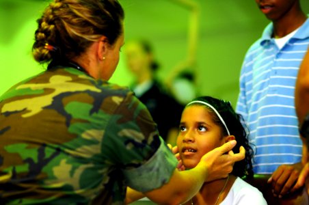 US Navy 081026-N-4515N-066 Lt. Cmdr. Kathaleen Sikes gives a young girl a routine check-up at the Arima District Health Facility